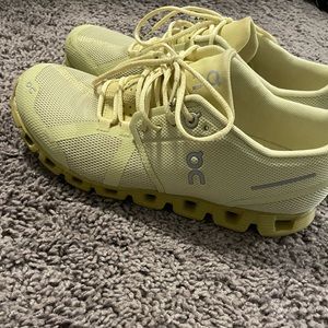 Yellow oncloud tennis shoes